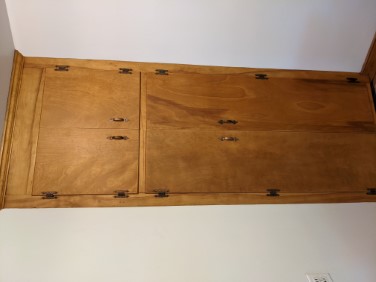 full wall-height refinished kitchen cabinets built into corner